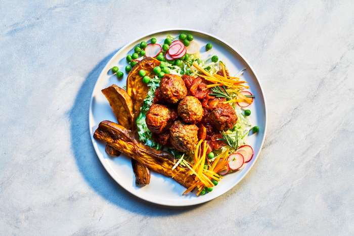 Photo of meatballs with sweet potato wedges and salad
