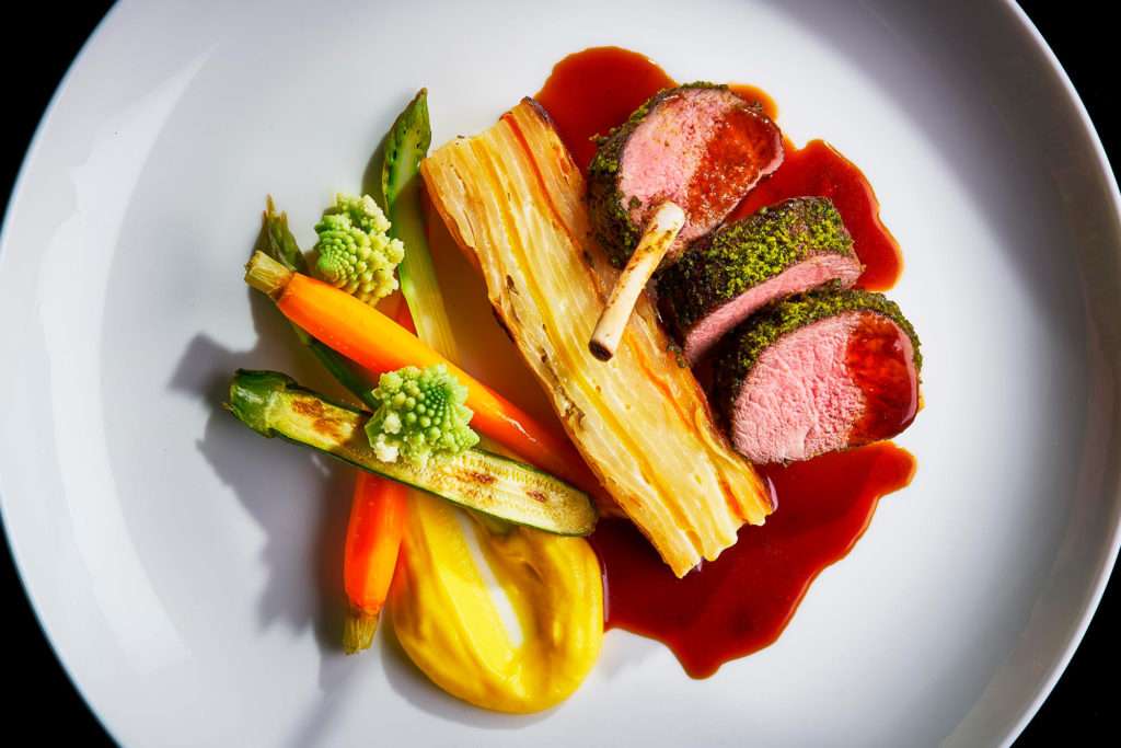 Roast Lamb with vegetables on white plate